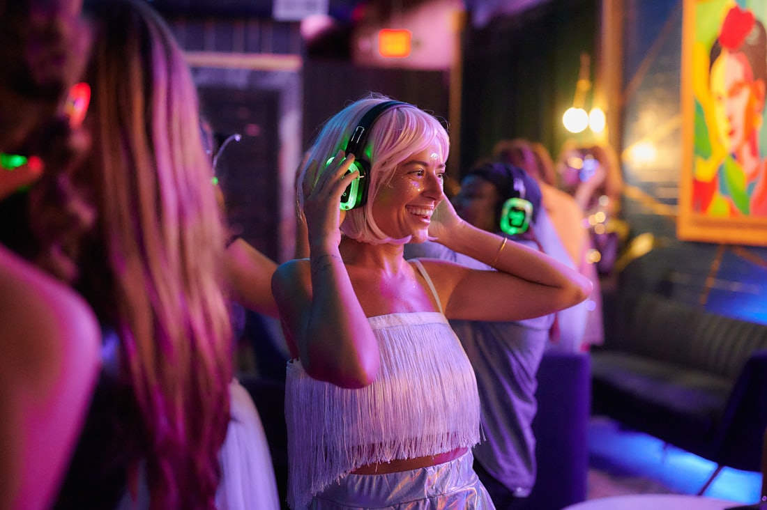 Guests dancing in glowing headphones
